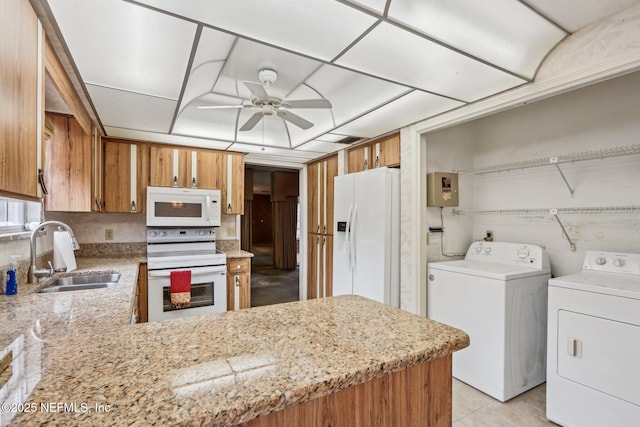 kitchen featuring sink, white appliances, washer and clothes dryer, ceiling fan, and kitchen peninsula