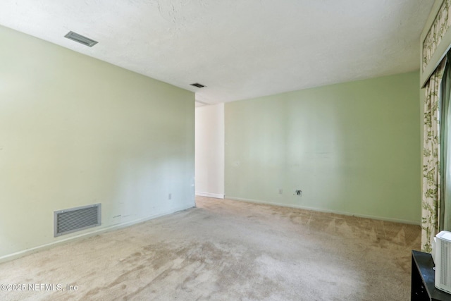 unfurnished room with light carpet