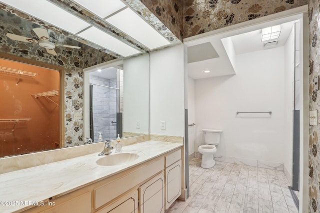 bathroom featuring vanity, hardwood / wood-style floors, toilet, and walk in shower