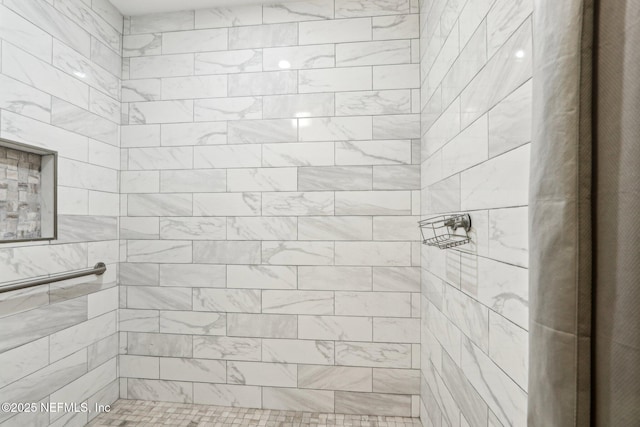 bathroom with a tile shower