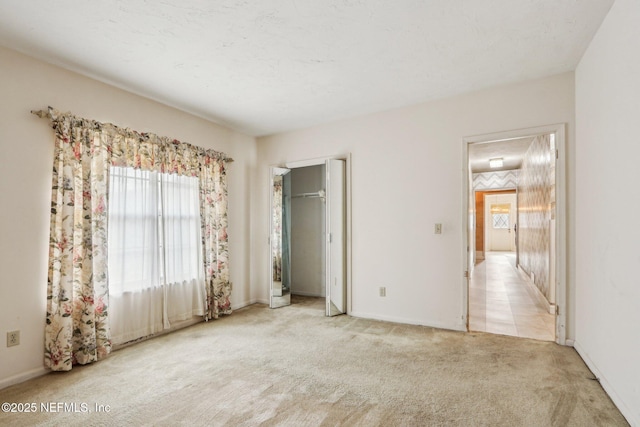 unfurnished bedroom with light colored carpet