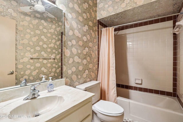 full bathroom featuring ceiling fan, vanity, toilet, and shower / tub combo