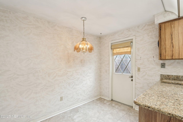 unfurnished dining area featuring a notable chandelier