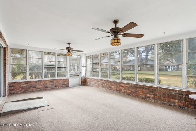 unfurnished sunroom featuring ceiling fan