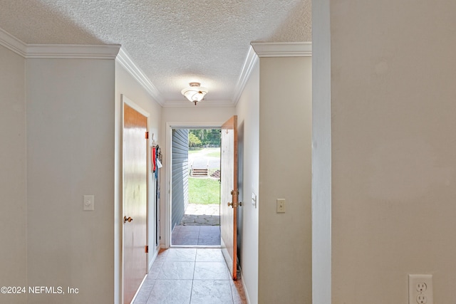 entryway with light tile patterned floors and crown molding