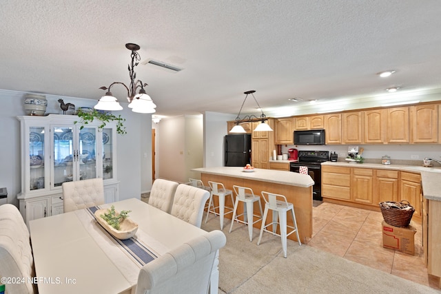 tiled dining space featuring sink, a textured ceiling, ornamental molding, and a notable chandelier