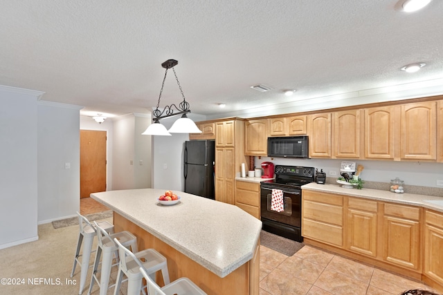 kitchen featuring a kitchen breakfast bar, hanging light fixtures, a kitchen island, crown molding, and black appliances