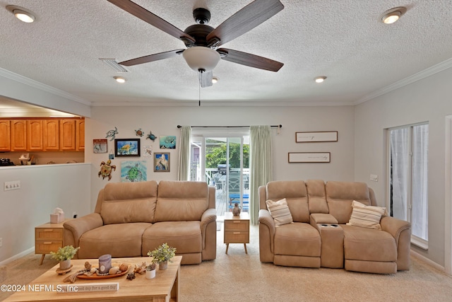 living room featuring a textured ceiling, ceiling fan, and ornamental molding