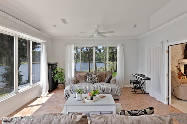 living room featuring ceiling fan, a wealth of natural light, and light tile patterned floors