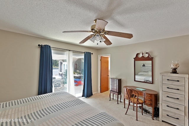 bedroom featuring light carpet, ceiling fan, and a textured ceiling