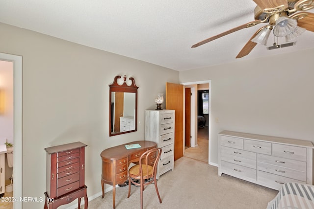 home office with ceiling fan, a textured ceiling, and light carpet