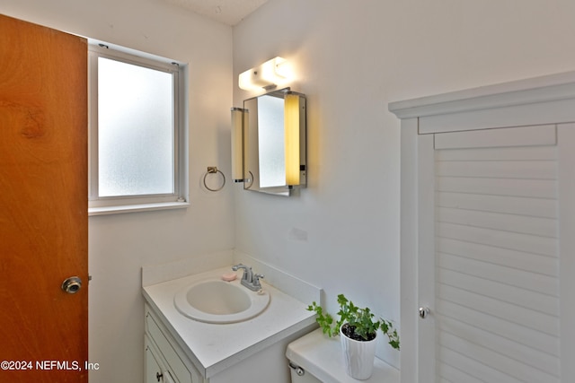 bathroom featuring toilet and vanity