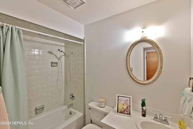 full bathroom featuring a textured ceiling, toilet, vanity, and shower / tub combo with curtain