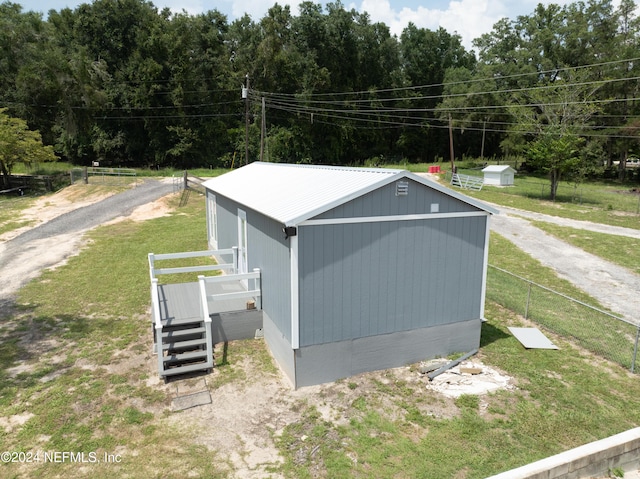 view of outbuilding featuring a yard