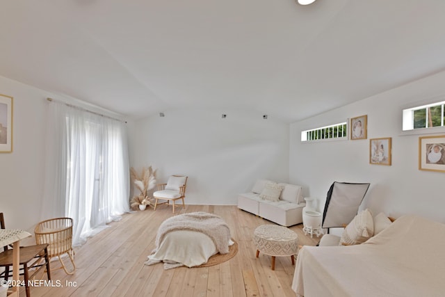 sitting room featuring vaulted ceiling, a healthy amount of sunlight, and light hardwood / wood-style floors