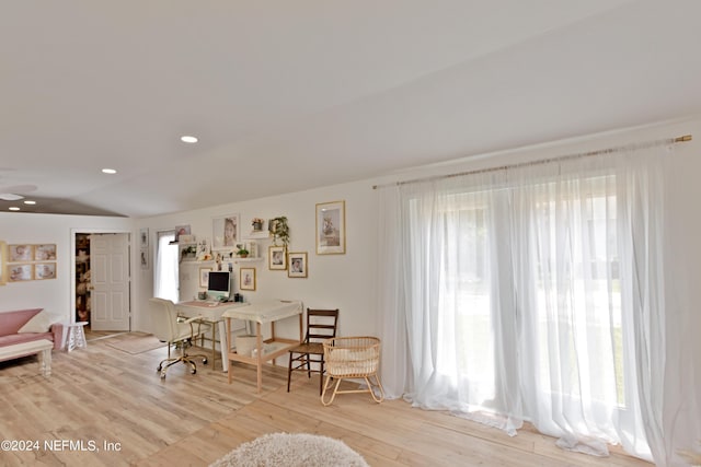 dining space featuring vaulted ceiling and light hardwood / wood-style flooring