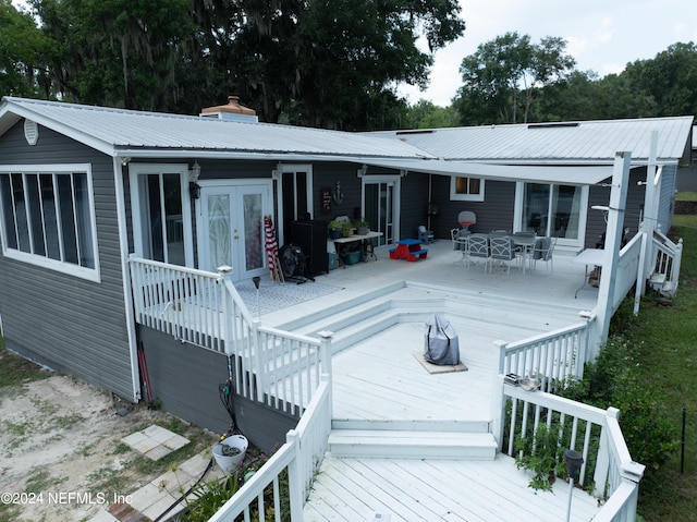 back of property featuring a wooden deck