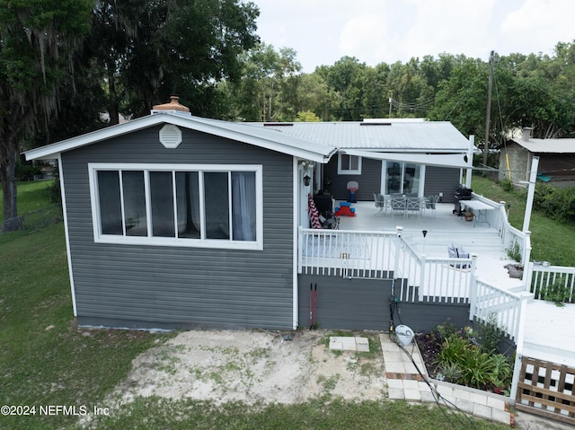 view of front of property with a front lawn and a wooden deck