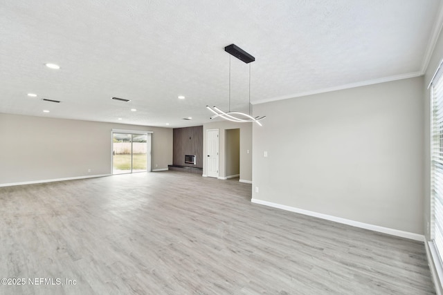 unfurnished living room featuring visible vents, light wood-style flooring, a textured ceiling, and baseboards