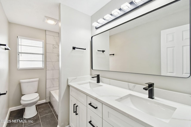 full bath with a sink, baseboards, toilet, and tile patterned floors