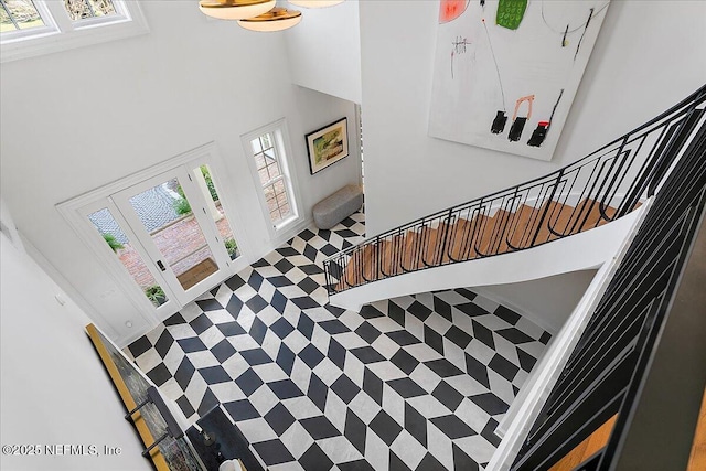 stairs featuring a high ceiling