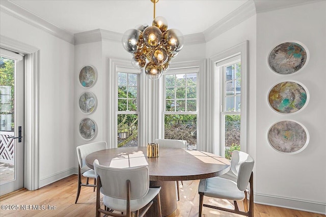 dining area featuring an inviting chandelier, plenty of natural light, and light hardwood / wood-style flooring