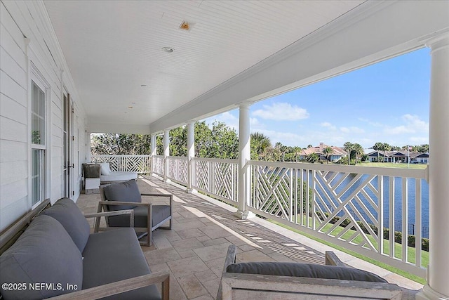 view of patio / terrace with an outdoor living space and a water view