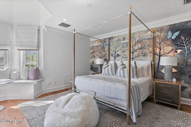 bedroom featuring wood-type flooring and ornamental molding