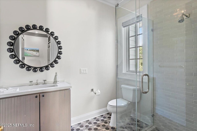 bathroom with toilet, an enclosed shower, and vanity