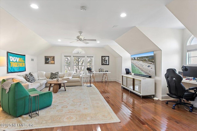 living room with ceiling fan, lofted ceiling, and wood-type flooring