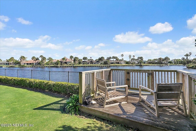 view of dock featuring a yard and a deck with water view