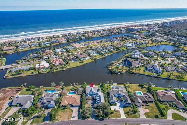 drone / aerial view featuring a view of the beach and a water view