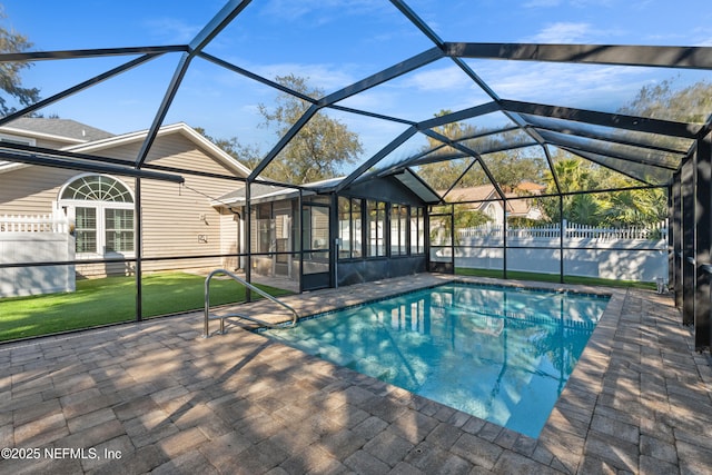 view of swimming pool featuring a sunroom, a patio, and glass enclosure