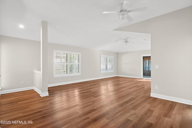 unfurnished room with vaulted ceiling, ceiling fan, and hardwood / wood-style floors