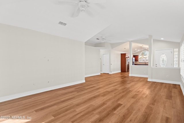 unfurnished living room featuring ceiling fan, light hardwood / wood-style floors, and vaulted ceiling