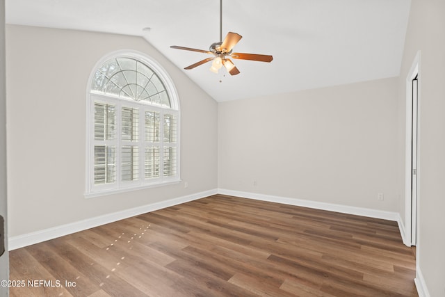 spare room with wood-type flooring, ceiling fan, and vaulted ceiling