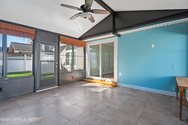 unfurnished sunroom featuring lofted ceiling, a healthy amount of sunlight, and ceiling fan