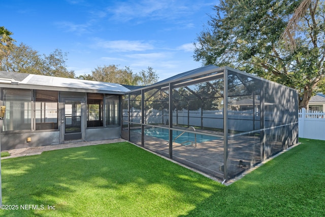 view of swimming pool with a yard and glass enclosure