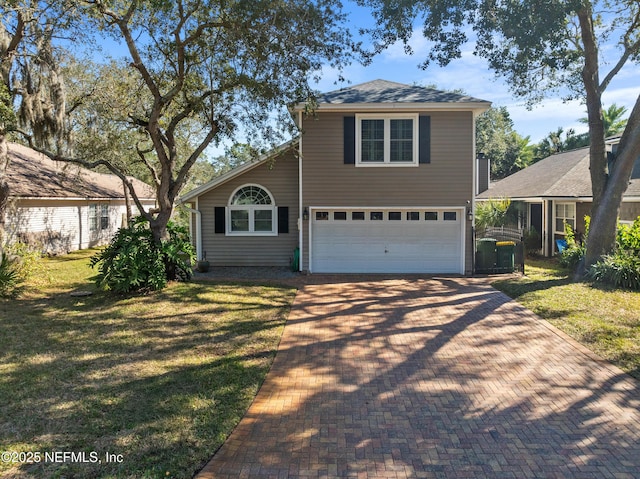 front of property featuring a garage and a front lawn