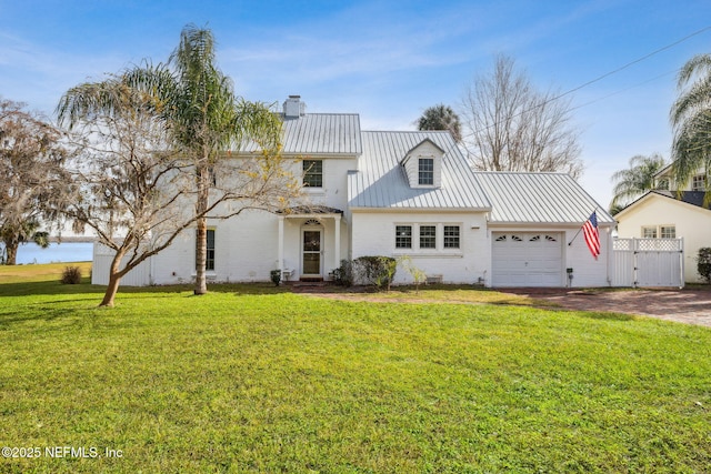 view of front of property with a front lawn and a garage