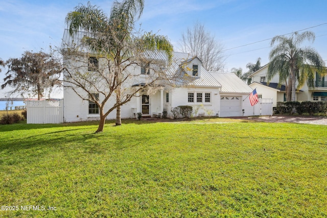 view of front of home with a front yard and a garage