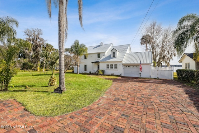 view of front of house with a garage and a front lawn