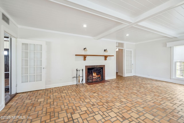 unfurnished living room with ornamental molding and beam ceiling