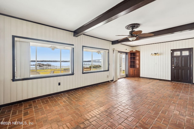 interior space with ceiling fan and beam ceiling