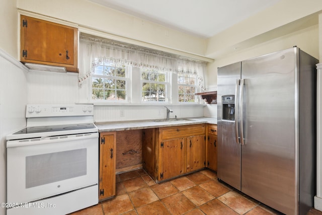 kitchen featuring stainless steel refrigerator with ice dispenser, sink, and white range with electric stovetop