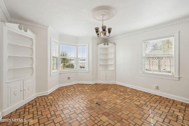 empty room featuring a wealth of natural light and a notable chandelier