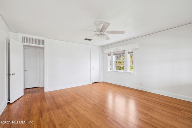 unfurnished room with ceiling fan and wood-type flooring