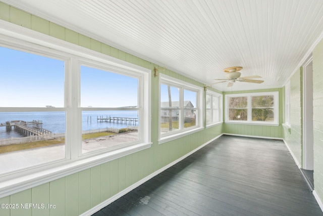 unfurnished sunroom with a water view and ceiling fan