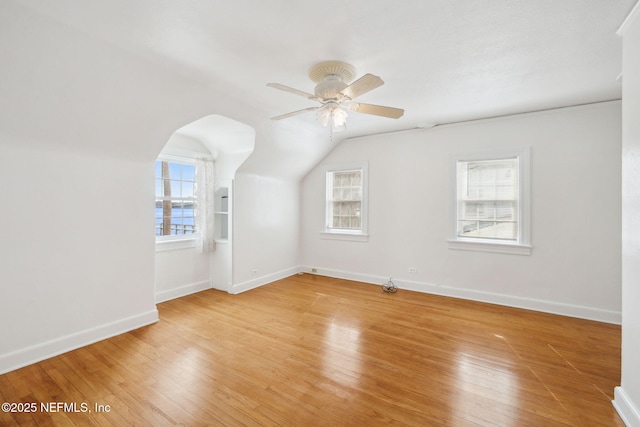 bonus room with ceiling fan, vaulted ceiling, light hardwood / wood-style floors, and a healthy amount of sunlight