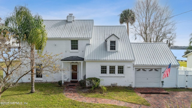 view of front of house featuring a garage and a front lawn